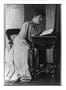 Historic Print (M): [Frances Hodgson Burnett, full-length portrait, seated, reading at a table]