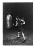 Historic Print (M): Corbett punching the bag to get in condition to handle Jeffries for the championship fig
