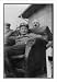 Historic Print (L): [Goering lounges in chair, two friends behind]