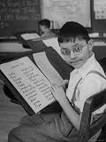 Student William de Mark Reads His Lessons in Larger Print Due to His Vision Problems Photographic Poster Print by Nina Leen, 30x40
