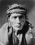 c1905 photo portrait of Navajo man, head-and-shoulders, facing front, rag headband, blanket over sho