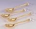SET OF FOUR GOLD PLATED SPOONS WITH CRYSTAL TIPS