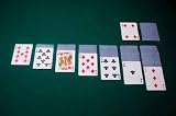 Playing Cards Are Set up for a Game of Solitaire, on Green Felt - 24