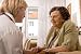 Senior Woman Is Visited by Her Doctor or Caregiver at Home - 48W x 32H - Peel and Stick Wall Decal by Wallmonkeys
