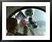 A Child (No Name Given) Looks Through a Window into the Pool of a Group of Seals Playing Underwater Framed Art Poster Print, 31x25