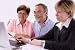 Mature Couple Talking to Financial Planner at Home - 48