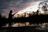Silhouette of the Hunter on a Background of a Morning Dawn - 24