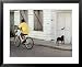 Boy Riding Bike in Front of House, with Stray Dog, Belize City, Belize World Culture Framed Art Poster Print by Anthony Plummer, 31x25