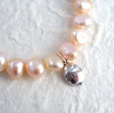 Click here to buy Sterling Silver Survivor Pink Pearl Breast Cancer Awareness Charm Bracelet.