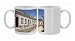 A row of traditional cottages front a cobbled street in the walled town of Photo Mugs