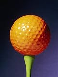 An Orange Golf Ball on a Green Tee with a Blue Background Premium Photographic Poster Print by Brian Gordon Green, 18x24