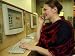 A Russian Woman Uses a Mobile Phone and Computer at an Internet Cafe Photographic Poster Print