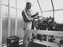 Man Potting His Plant in the Plastic Greenhouse Photographic Poster Print by Fritz Goro, 12x16