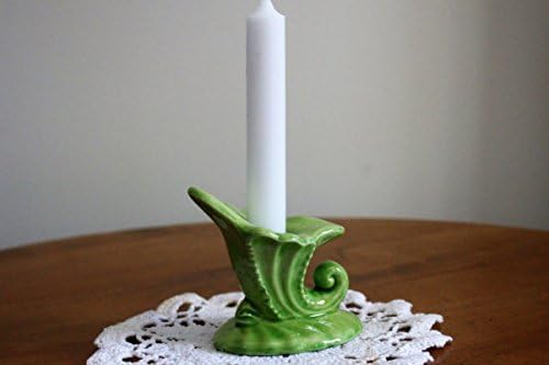 This is a small mint green cornucopia shaped ceramic candleholder.