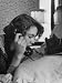 Young Lady Talking on Telephone with a Friend, in Privacy of Her Parent's Bedroom Photographic Poster Print by Gordon Parks, 30x40