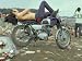 Shirtless Man in Levi Strauss Jeans Lying on Motorcycle Seat at Woodstock Music Festival Photographic Poster Print by Bill Eppridge, 16x12