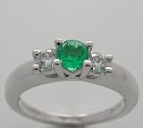 Platinum Classic Three Stone Ring Centering One Emerald 0.28 Ct And Accented With 2 Side Diamonds