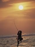 Fisherman Balanced on a Stilt at Sunset Photographic Poster Print by Carsten Peter, 18x24