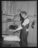 Photo: Putting out newspaper. Tulare migrant camp. Visalia,California 1