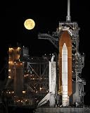 A Nearly Full Moon Sets as Space Shuttle Discovery Sits atop the Launch Pad. - 24