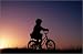 Girls Bikes 20 photo poster Girl on a bike, silhouetted. in size: 30 x 20 cm by M. Coyne