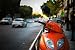 Orange Scooter Parked besides a Street with Traffic - Peel and Stick Wall Decal by Wallmonkeys