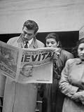 Couple Reading Newspaper Account of the Death of Evita Peron at 33 from Cancer Photographic Poster Print by Alfred Eisenstaedt, 24x32
