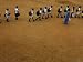 Children Follow Their Teacher as They Head Back to School for the First Time after th...