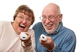 Active Senior Couple Play Video Game with Remotes - 72