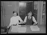 Photo: Putting out newspaper. Tulare migrant camp. Visalia,California