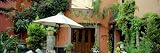 Patio Umbrella in Front of a Building, San Miguel De Allende, Mexico by Panoramic Images , 20x60