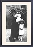 IMAGE OF Framed Prints of Two children in white and a woman in black from Mary Evans