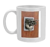Photo Mug of DOG. Schnauzer puppy coming through cat flap from Ardea