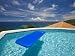 Blue Raft Floats in a Pool Overlooking the Caribbean Sea Photographic Poster Print by Michael Melfor