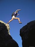41ipFuvgGqL. SL160  Young Woman Leaping a Gap Between Rock Formations Artists Photographic Poster Print, 18x24