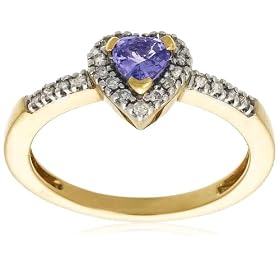 Twenty-two diamonds (.435 cttw) surround a heart-shaped tanzanite stone in this precious 14 karat yellow gold ring. The diamonds create a heart-shaped border around the tanzanite stone and continue along the shoulders of the simple yellow gold band. Tanzanite is a rare and much coveted gemstone, prized for its unique color--a radiant blue tinged with purple. Elegant and charming, this tanzanite ring makes a beautiful gift for someone special.