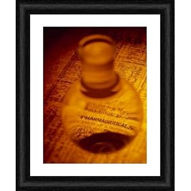 Framed 10x8 Print (25x20cm) Pharmaceutical flask on a newspaper finance page by Science Photo Library