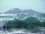Waves with Anak Krakatoa Volcano Behind, Sunda Straits, Indonesia Photographic Poster Print by Mary Plage, 56x42
