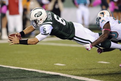 New York Jets and Miami Dolphin: Mark Sanchez and Reshad Jones Photographic Poster Print by Bill Kostroun, 18x12