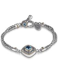 18KY & Sterling Silver This Sara Blaine Sterling Silver and 18k yellow gold bracelet features a 6mm blue topaz focal stone with 2 blue topaz accent stones on the toggle clasp.