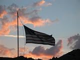 American Flag Rises at Sunset Above a Cemetery, Nevada Photographic Poster Print by Charles Kogod, 12x16