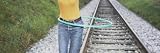 Woman Playing with a Plastic Hoop on a Railroad Track, Germany Photographic Poster Print by Panoramic Images, 36x12