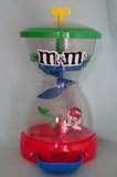 M&M M & M Candy Dispenser -- M&Ms Drop Onto SeeSaw To Raise Character -- as shown