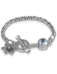 Sterling Silver This sterling silver Sara Blaine bracelet features a beautiful 8 mm blue topaz and a sterling silver flower charm.