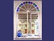 Arched Mirror with Bottles in Window