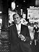 Playwright Moss Hart Holding Pipe While Leaning on Lamppost in the Middle of Times Sq...