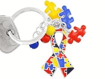 New Silver Finish Key Chain Suspending an Autism Awareness Ribbon and Multicolored Puzzle Pieces Beside Colorful Beads.