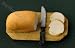 Miniature Artisan Loaf of Sliced Bread on a Bread Board