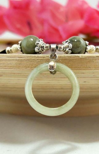 Click here to buy Jade Ring Pendant on a Velvet rope Choker Necklace Pendant Size: .85 Necklace length 16.5.