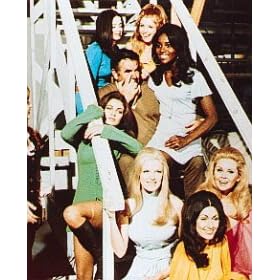 MARCIA MCBROOM AS PETRONELLA DANFORTH, DOLLY READ AS KELLY MCNAMARA, LAVELLE ROBY AS VANESSA, EDY WILLIAMS AS ASHLEY ST. IVES, RUSS MEYER AS TV CAMERAMAN, CYNTHIA MYERS AS CASEY ANDERSON FROM BEYOND THE VALLEY OF THE DOLLS #1 - COLOUR Movie Photo - (4 Different Photograph & POSTER Sizes Available)